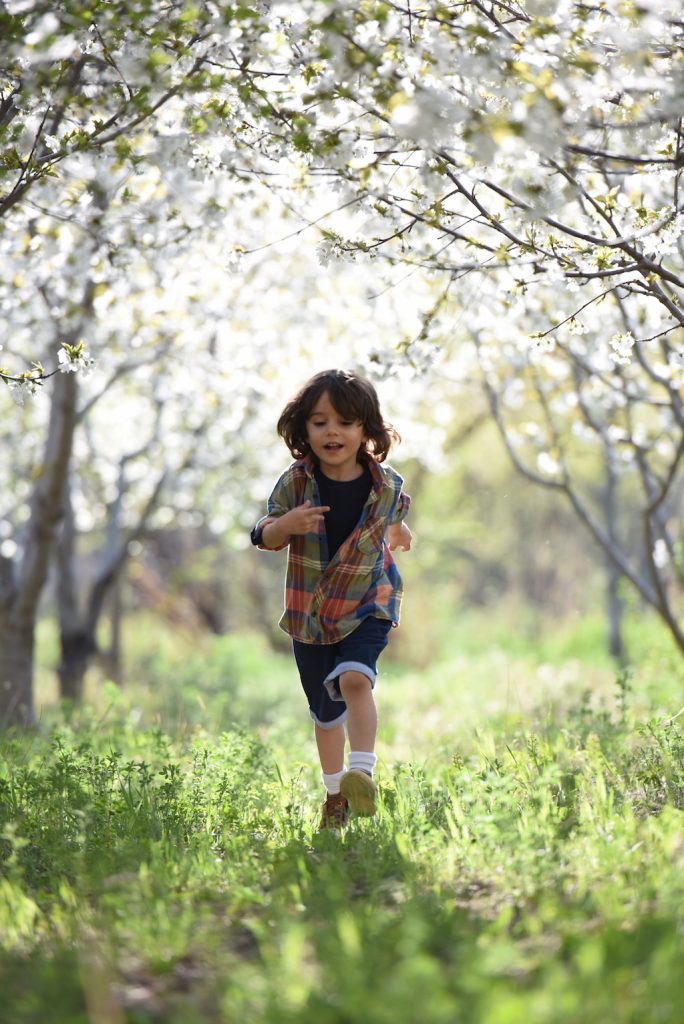 Boy running through trees