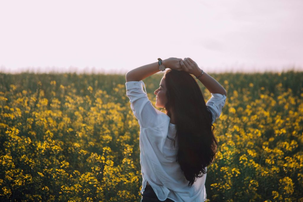 A girl enjoys being outdoors in a field of flowers