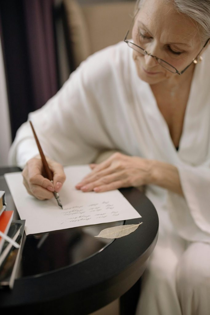 A woman writing a letter of thanks and gratitude

